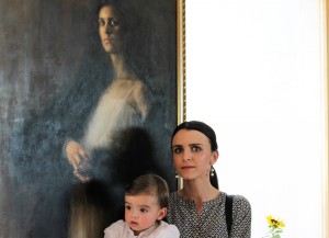 Greed 193x89 - the model and her baby standing in front of the painting