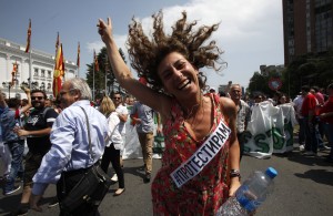 A woman dances while protesting in front of the Government building in Skopje, Macedonia, on Sunday, May 17, 2015. Macedonian opposition started massive demonstrations Sunday in Skopje protesting against the conservative government of the Prime Minister Nikola Gruevski, demanding its resignation. The banner strip reads "I Ptotest". (AP Photo/Boris Grdanoski)