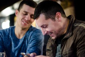 December 30, 2014 - Ferizaj, Kosovo – Dardan Marevci left, looks at photos from Afghanistan with his cousin, Ilir, who also worked there at the same time. | Photo: Valerie Plesch 