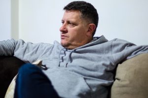 January 4, 2015 - Ferizaj, Kosovo – Fatmir Ferati sits in his new home, which he built with money saved from working six years in Afghanistan. In 2012, he was badly injured in an accident while working at Bagram Airfield when an American soldier crashed into him on a forklift. He returned to Kosovo and had to undergo months of physical therapy. | Photo: Valerie Plesch