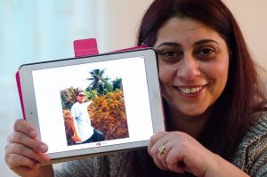 January 6, 2015 – Gjilan, Kosovo - Lira Dermaku holds a photo of her husband, Adnan, who deployed to Liberia in December to work on a USAID-funded project to fight Ebola. Before Liberia, he worked in Afghanistan and Iraq since 2006. | Photo: Valerie Plesch