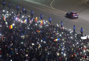 Protesters are cordoned in front of the government building in Bucharest, Romania, Tuesday, Feb. 7, 2017. Romania's president Klaus Iohannis told lawmakers Tuesday the country is in a "fully-fledged" political crisis, after hundreds of thousands demonstrated against a government measure that would weaken the country's anti-corruption drive. (AP Photo/Darko Bandic)