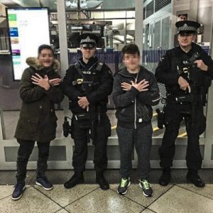 Albanian minors enjoying taking pictures with British cops. | Photo: Facebook