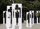 Pedestrians walk past by silhouettes symbolising missing persons in Prishtina, Kosovo on August 30, 2021. Photo: EPA/VALDRIN XHEMAJ
