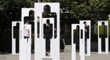 Pedestrians walk past by silhouettes symbolising missing persons in Prishtina, Kosovo on August 30, 2021. Photo: EPA/VALDRIN XHEMAJ