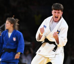 Laura Fazliu of Kosovo (white) celebrates winning over Katarina Kristo of Croatia (blue) during their Women -63kg Semifinal bout of the Judo competitions in the Paris 2024 Olympic Games, at the Champs-de-Mars Arena in Paris, France, 30 July 2024. EPA-EFE/CAROLINE BLUMBERG