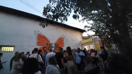 Dokufest attendees enter the Lumbardhi Bahce in Prizren for the festival’s opening, passing a mural of a butterfly with the festival slogan ‘New Order’. Photo: BIRN