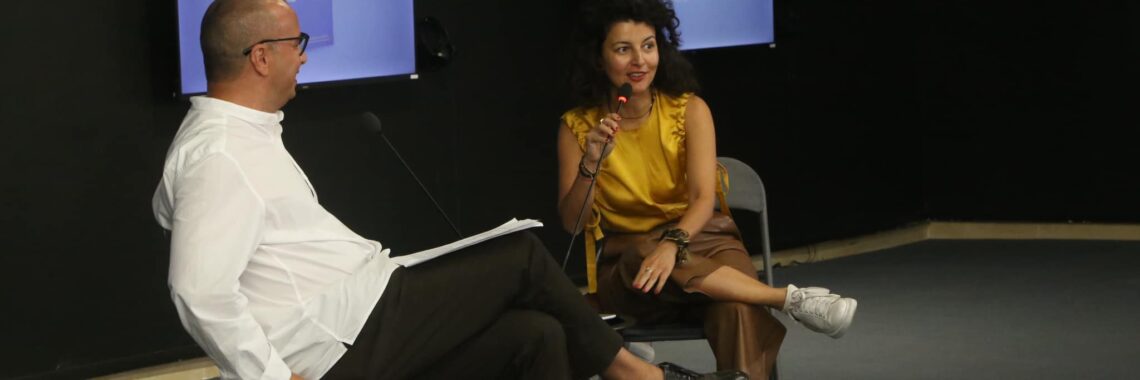 Fatos Üstek, UK based curator and writer presenting her latest book: “The Art Institution of Tomorrow: Reinventing the Model,” at Reporting House on September 6 in Prishtina, Kosovo. Photo: BIRN