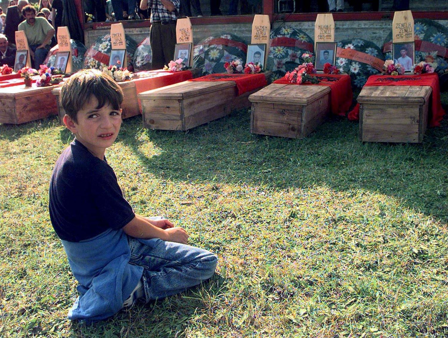 A young Kosovar boy cries next to the coffin of his father at the local cemetery, some 50km west from Kosovo capital Prishtina on September 19,1999. PHOTO: EPA/ATTILA KISBENEDEK