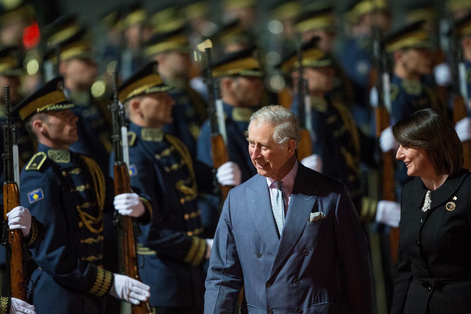 Prince of Wales and the former President of the Republic of Kosovo Atifete Jahjaga (R) inspect the honor guard of the Kosovo Security Force (KSF) upon his arrival at the Adem Jashari Airport, in Slatina, Kosovo, 18 March 2016. Photo: EPA/VALDRIN XHEMAJ