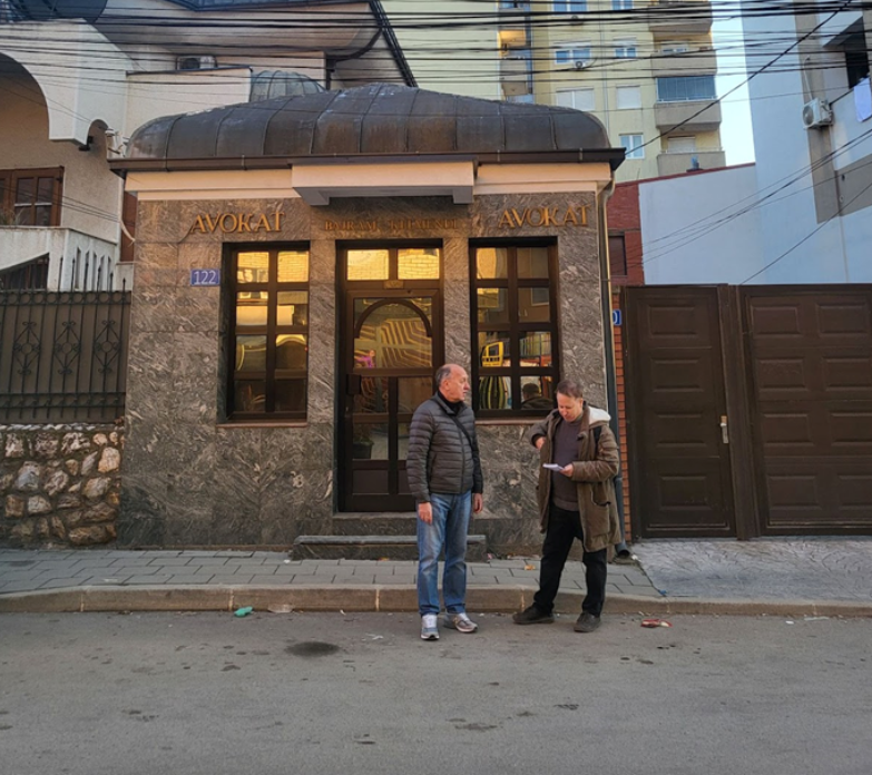 Grygorenko and Anderson in front of murdered lawyer Bajram Kelmendi’s office in Prishtina. Photo by Hana Xharra Anderson