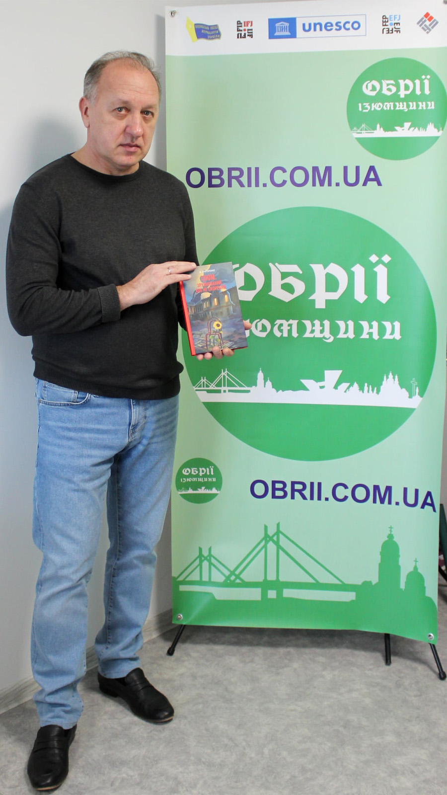 Kostyantyn Grygorenko holding his book. Photo courtesy of Kostyantyn Grygorenko