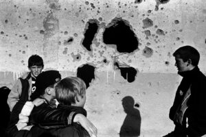 Young boys stand in front of the ruins of Adem Jashari's house, destroyed by Serbian forces in Prekaz. Photo: Joakim Roos