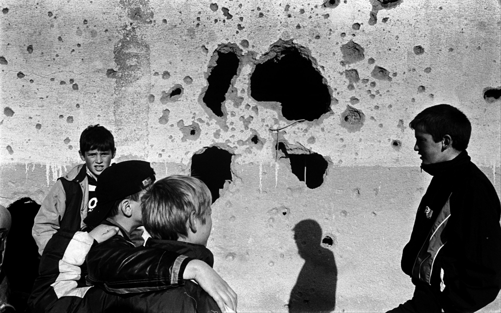 Young boys stand in front of the ruins of Adem Jashari's house, destroyed by Serbian forces in Prekaz. Photo: Joakim Roos