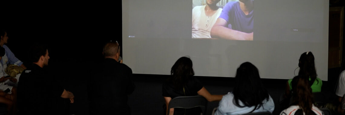 Hussein al-Jerjaw (L) and his brother Asem (R) during a talk, via Zoom video call from Gaza, at BIRN's Reporting House exhibition in Kosovo's capital, Prishtina. Photo: BIRN/Jetmir Hoxha