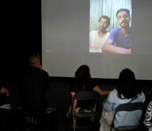 Hussein al-Jerjaw (L) and his brother Asem (R) during a talk, via Zoom video call from Gaza, at BIRN's Reporting House exhibition in Kosovo's capital, Prishtina. Photo: BIRN/Jetmir Hoxha