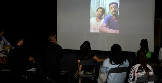 Hussein al-Jerjaw (L) and his brother Asem (R) during a talk, via Zoom video call from Gaza, at BIRN's Reporting House exhibition in Kosovo's capital, Prishtina. Photo: BIRN/Jetmir Hoxha