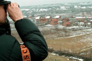 An OSCE officer checks the Studencane and Suva Reka area in Kosovo, February 1999. Photo: EPA/ATTILA KISBENEDEK/STF/AK/CL/OW.