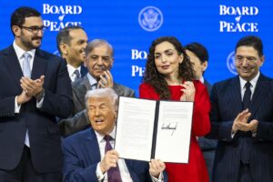 US President Donald Trump (C) holds a signed founding charter at the 'Board of Peace' meeting during the 56th annual meeting of the World Economic Forum (WEF), in Davos, Switzerland, 22 January 2026. Photo: EPA/Gian Ehrenzeller
