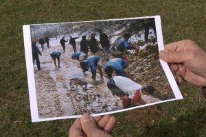 Gani Kosumi holds his photograph showing footballers having a wash in a stream after a match in March 1997. Photo: BIRN.