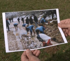 Gani Kosumi holds his photograph showing footballers having a wash in a stream after a match in March 1997. Photo: BIRN.