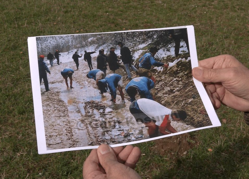 Gani Kosumi holds his photograph showing footballers having a wash in a stream after a match in March 1997. Photo: BIRN.